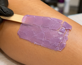 Close-up of cracked Wax by Yeni hard wax on skin, showing a common waxing mistake caused by improper application or temperature.