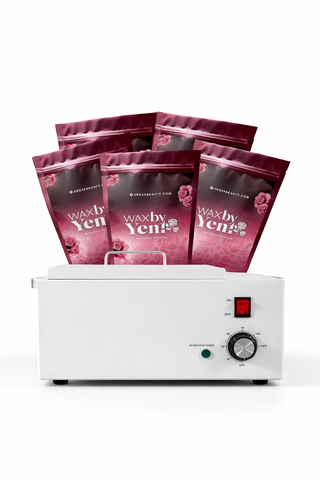 Waxing kit with multiple wax packets and a warmer on a white background