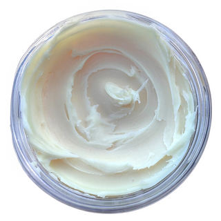 Creamy white substance in a clear container on a white background